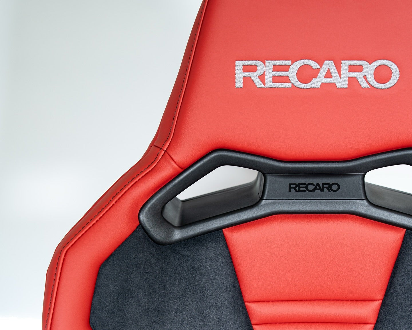 Red and black RECARO SR-S chair with visible branding on a white background