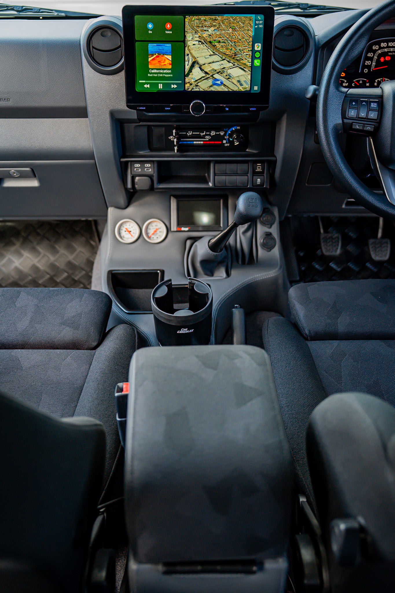 Car interior with a focus on the dashboard and steering wheel.