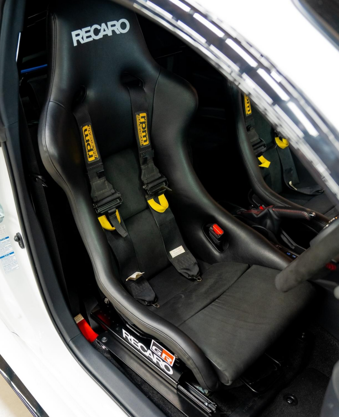 Close-up of a car seat with Recaro branding inside a vehicle.